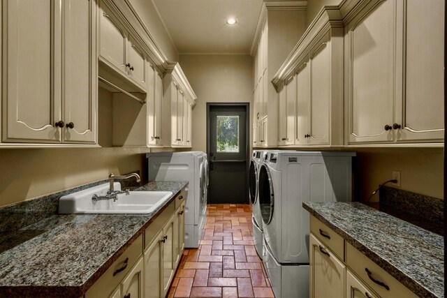 washroom with separate washer and dryer, sink, crown molding, and cabinets