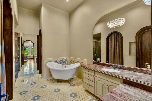 bathroom with vanity, a bathing tub, and tile patterned flooring