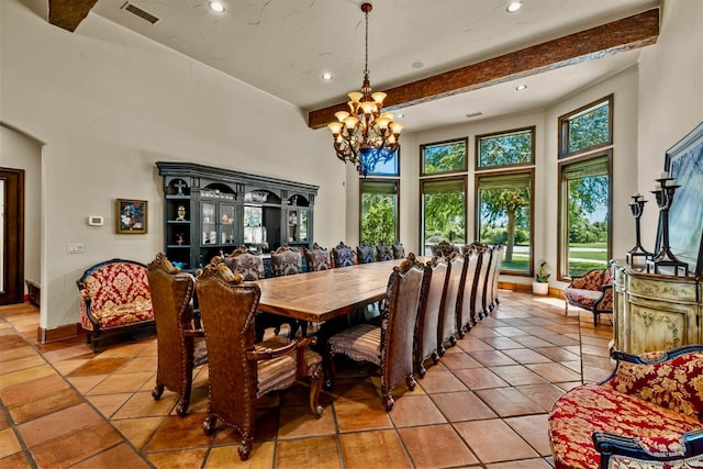 dining space with light tile patterned floors, beam ceiling, and a chandelier