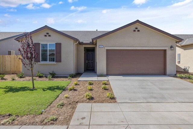 single story home featuring a garage and a front lawn