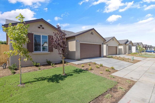 ranch-style house featuring a garage and a front lawn