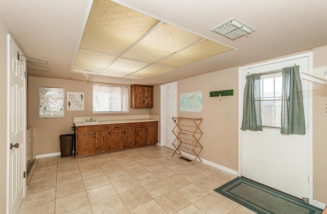 kitchen featuring light tile patterned floors and sink