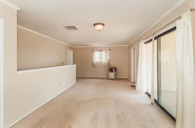 carpeted spare room featuring crown molding