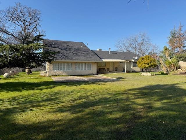 back of house with a patio and a yard