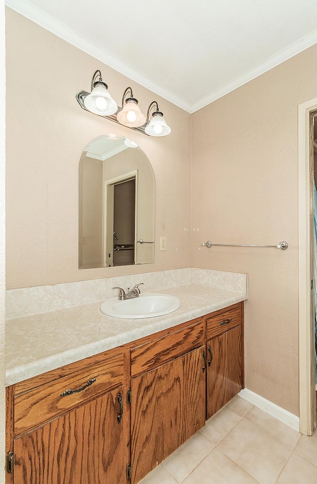 bathroom featuring tile patterned flooring, vanity, and crown molding