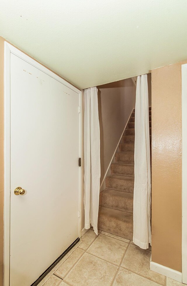 stairway with tile patterned flooring