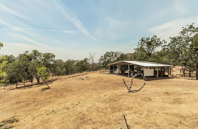 view of yard with a rural view and an outdoor structure