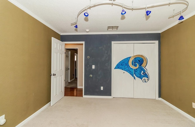 unfurnished bedroom with light colored carpet, ornamental molding, and a closet