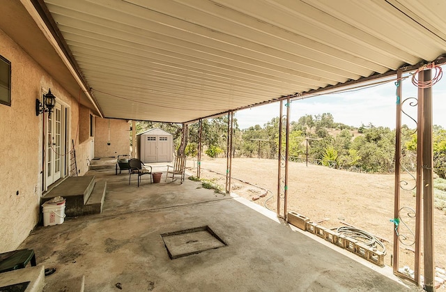 view of patio featuring a storage unit