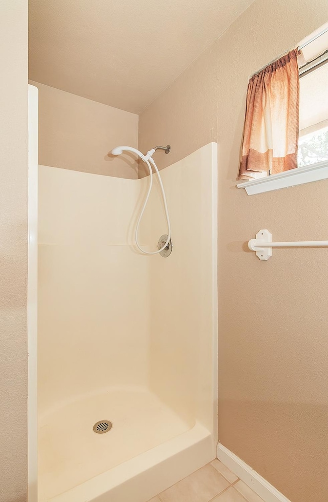 bathroom featuring a shower and tile patterned floors