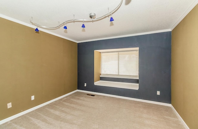 carpeted empty room with a textured ceiling and crown molding