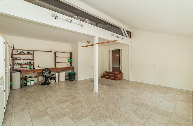 interior space featuring light tile patterned flooring and lofted ceiling