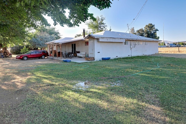 view of home's exterior featuring a lawn and a patio area