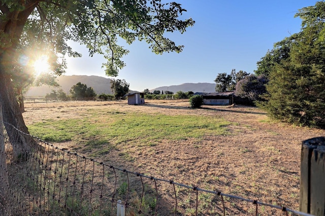 view of yard with a mountain view and a rural view