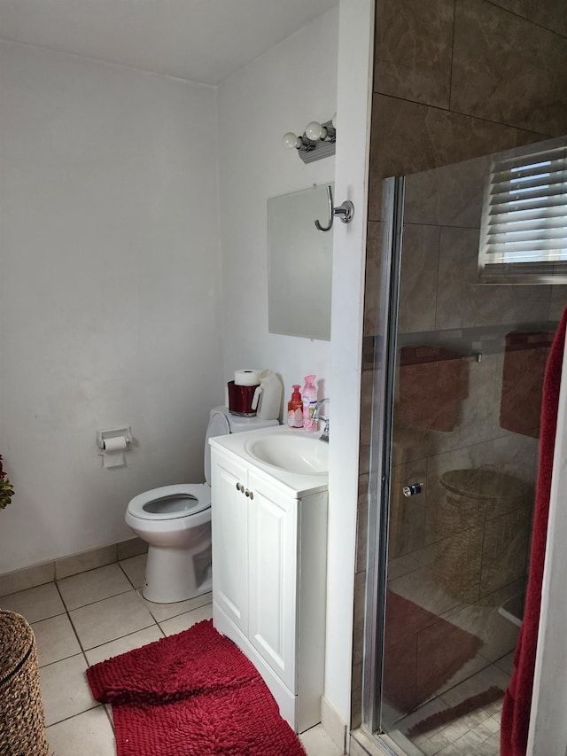 bathroom featuring vanity, toilet, tile patterned floors, and a shower with shower door