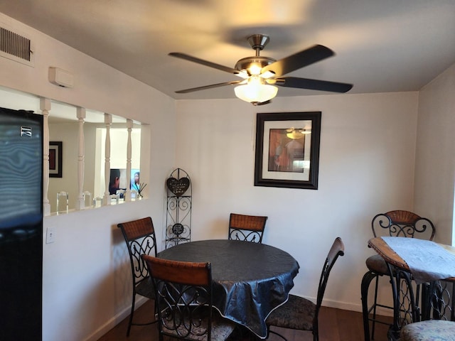 dining room featuring dark hardwood / wood-style floors and ceiling fan