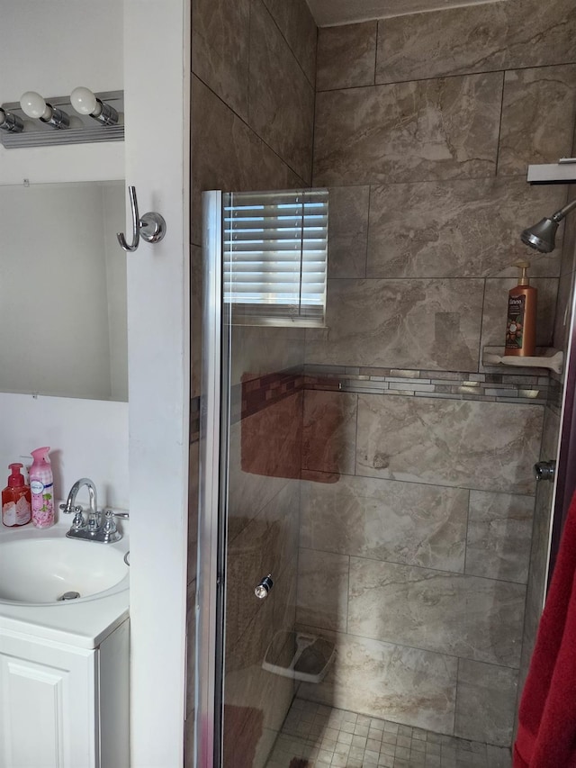 bathroom with a shower with door and vanity