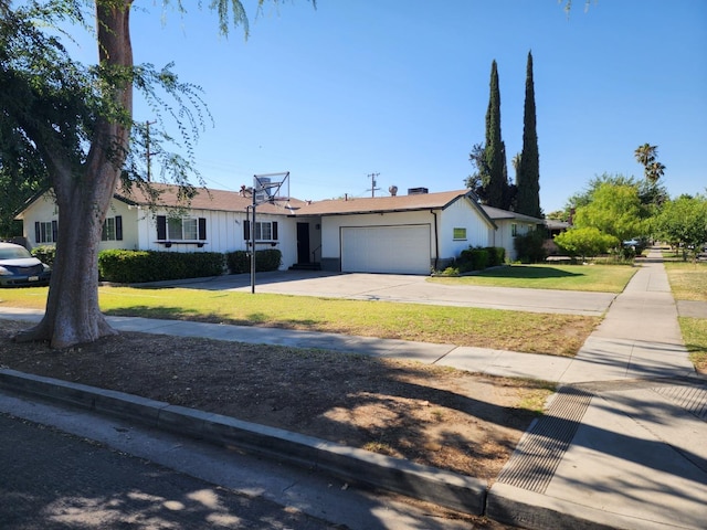 ranch-style home featuring a garage and a front lawn