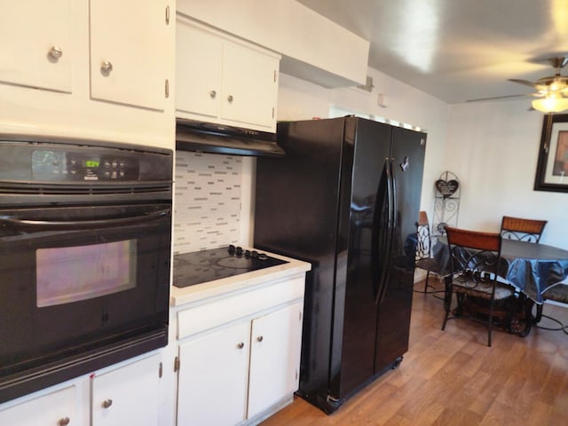 kitchen featuring white cabinetry, backsplash, light hardwood / wood-style floors, and black appliances