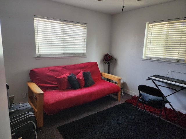 sitting room featuring ceiling fan and carpet floors