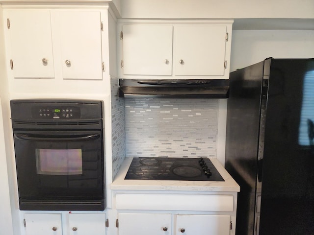 kitchen featuring backsplash, black appliances, and white cabinets