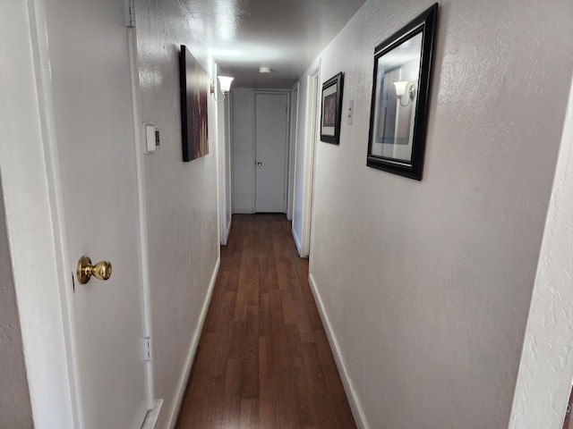 hallway featuring dark hardwood / wood-style floors