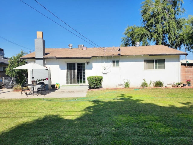 rear view of house with a yard and a patio area