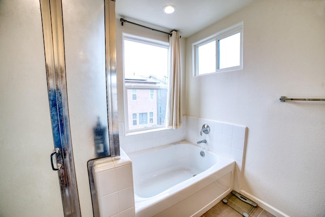 bathroom featuring a wealth of natural light, tile flooring, and separate shower and tub