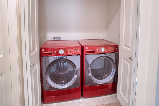 clothes washing area featuring independent washer and dryer, washer hookup, and tile floors