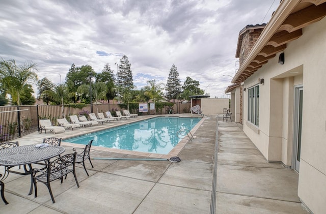 view of swimming pool with a patio area