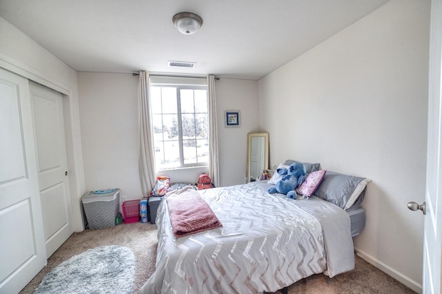 carpeted bedroom with a closet