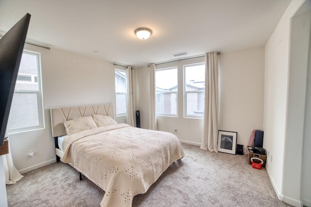 bedroom featuring carpet flooring and multiple windows