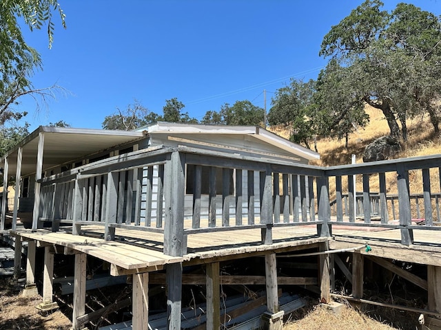 rear view of house with a wooden deck