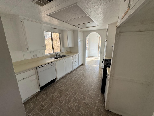 kitchen featuring sink, dishwasher, and white cabinetry