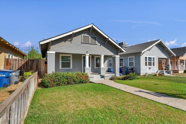 bungalow featuring a front yard and central air condition unit