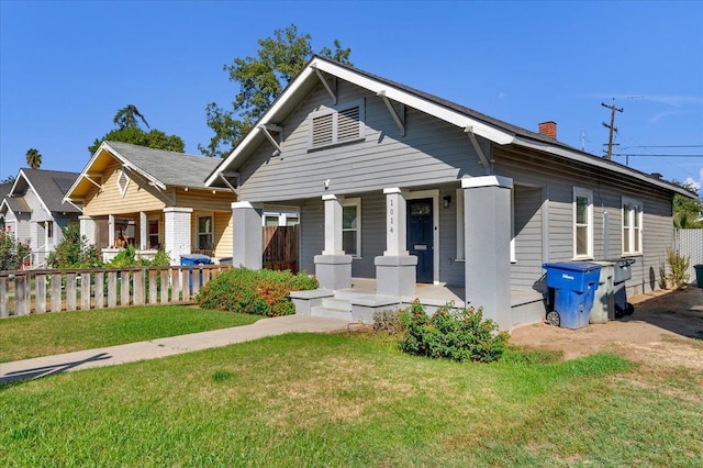 view of front of property with a front yard and a porch