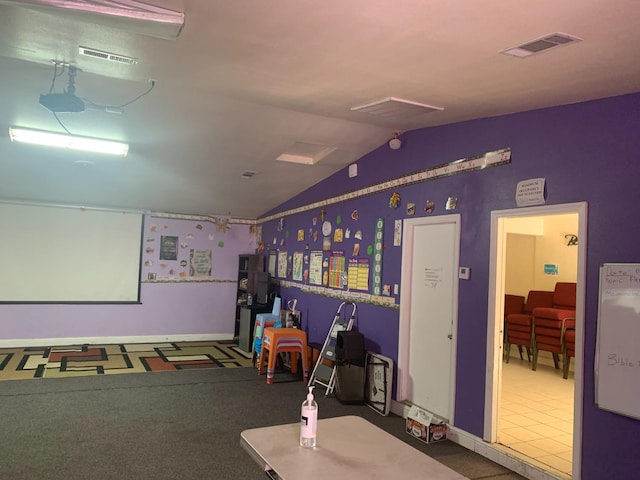 playroom with tile floors and lofted ceiling