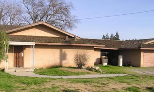 view of side of home with a lawn