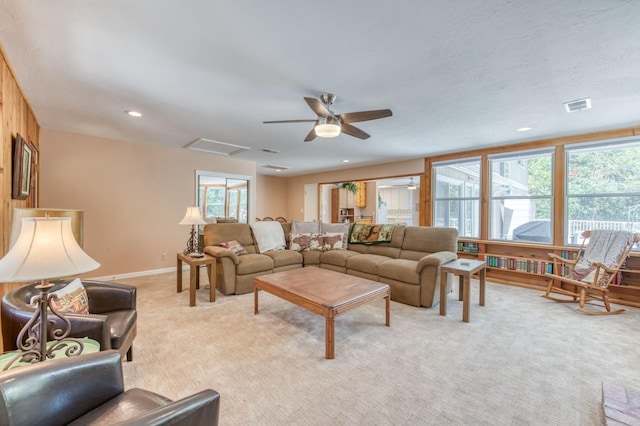 carpeted living room with plenty of natural light and ceiling fan