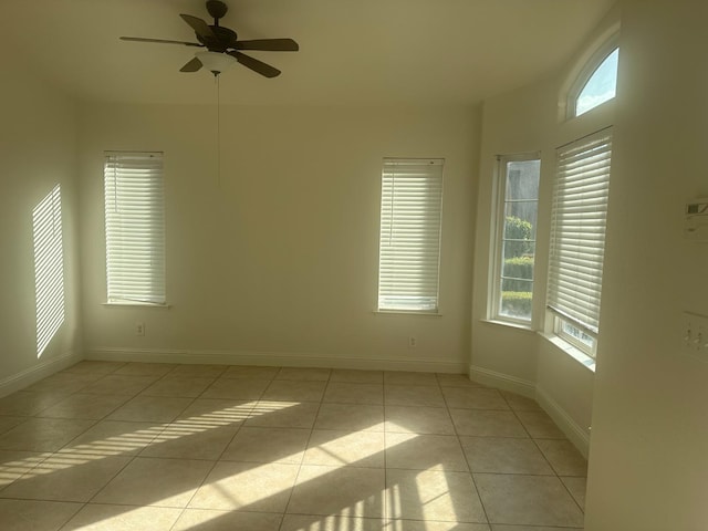 empty room featuring ceiling fan and light tile patterned floors