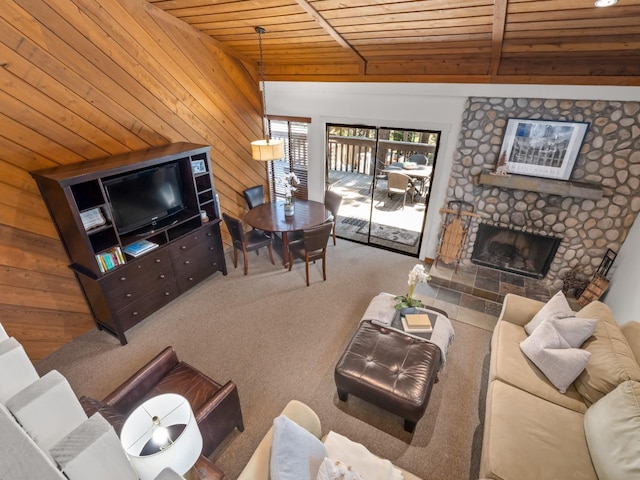 living room featuring carpet, wood ceiling, wood walls, and a fireplace