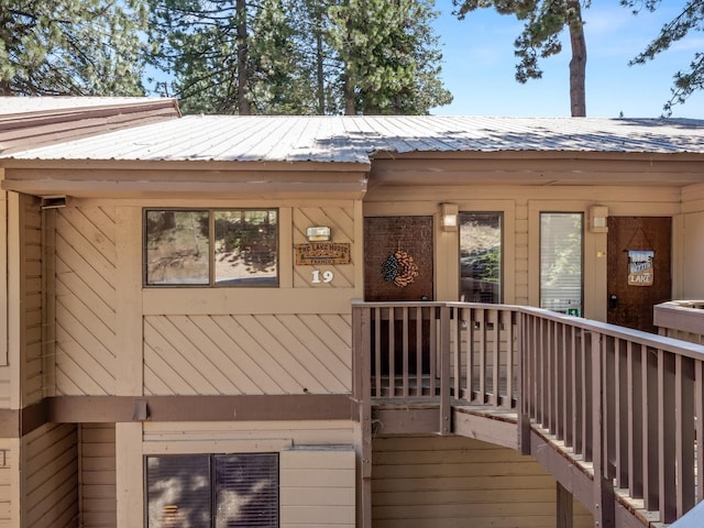 entrance to property featuring metal roof