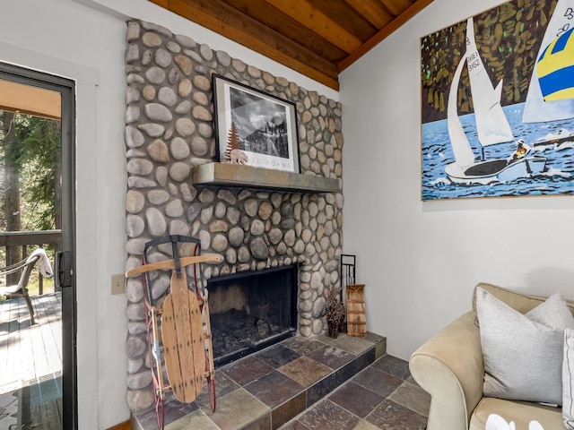 living room with stone tile flooring, a fireplace, and wood ceiling