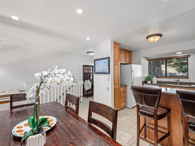 dining space with light tile patterned floors and recessed lighting