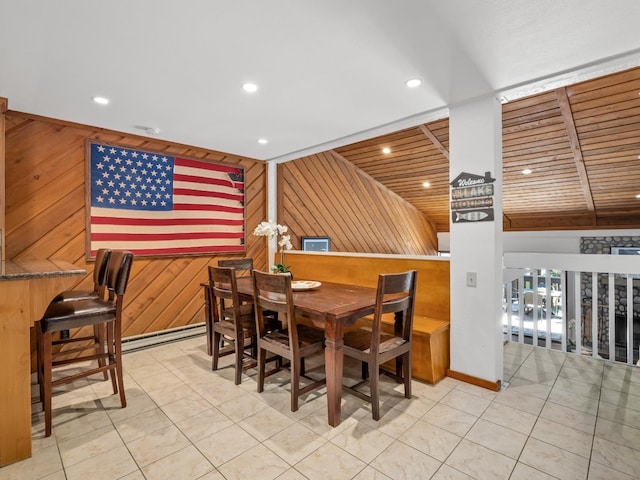 dining space with wooden walls, light tile patterned floors, recessed lighting, and baseboard heating