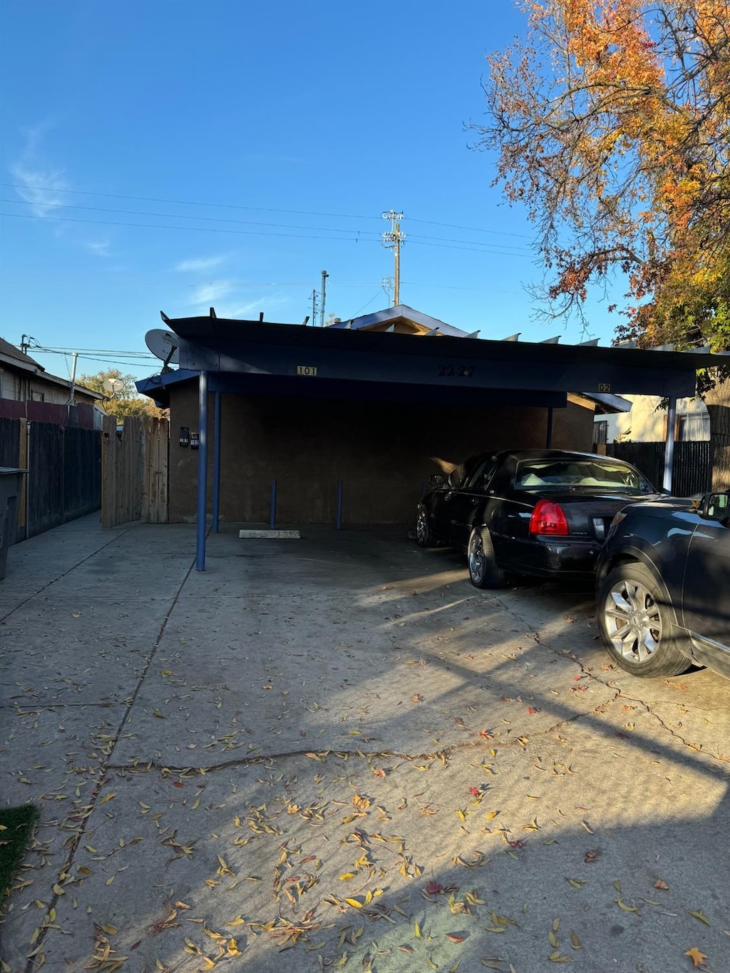 view of parking / parking lot featuring a carport