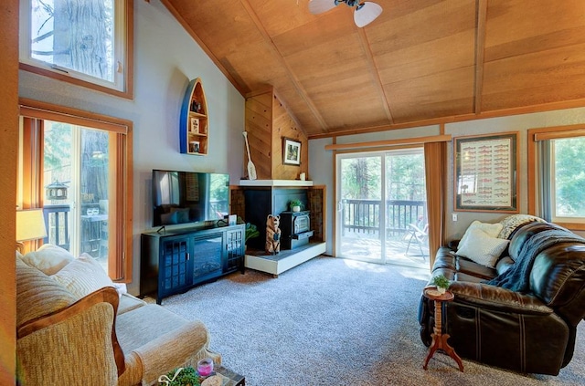 living room featuring carpet flooring, a wood stove, ceiling fan, wooden ceiling, and lofted ceiling