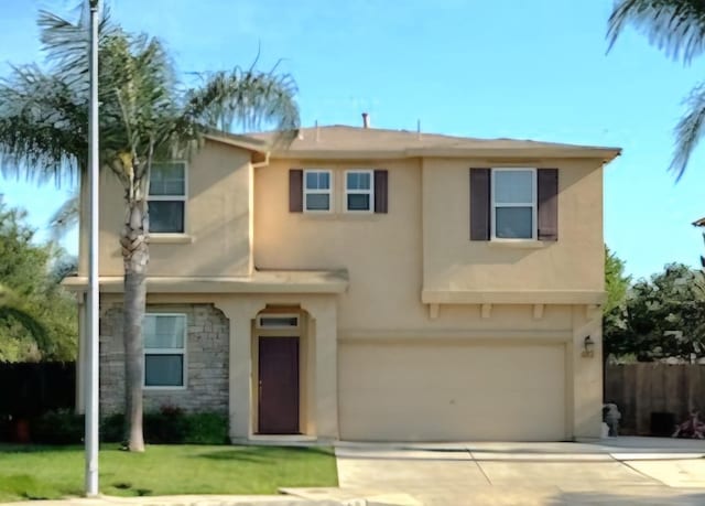 view of front of home featuring a front yard and a garage