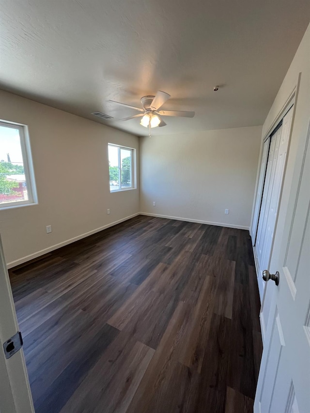 empty room with wood-type flooring and ceiling fan