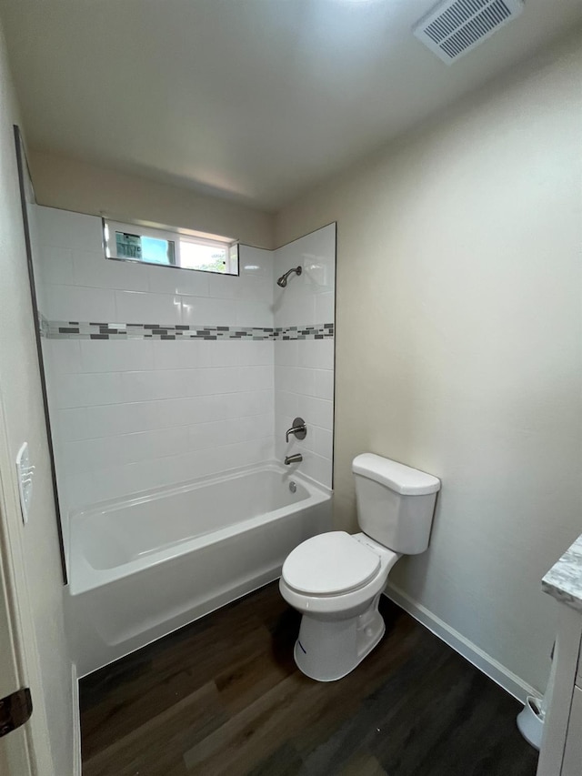 full bathroom featuring vanity, tiled shower / bath, toilet, and hardwood / wood-style floors